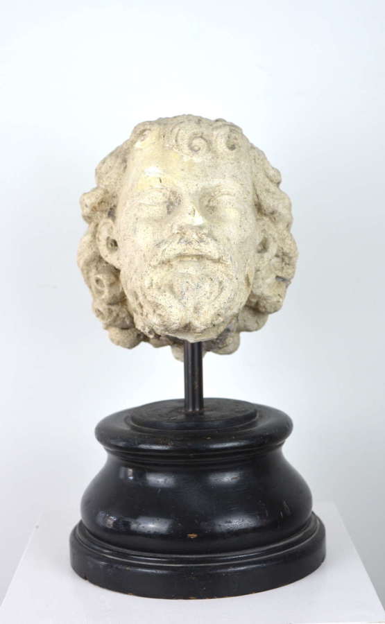 A CARVED STONE HEAD, POSSIBLY MEDIEVAL